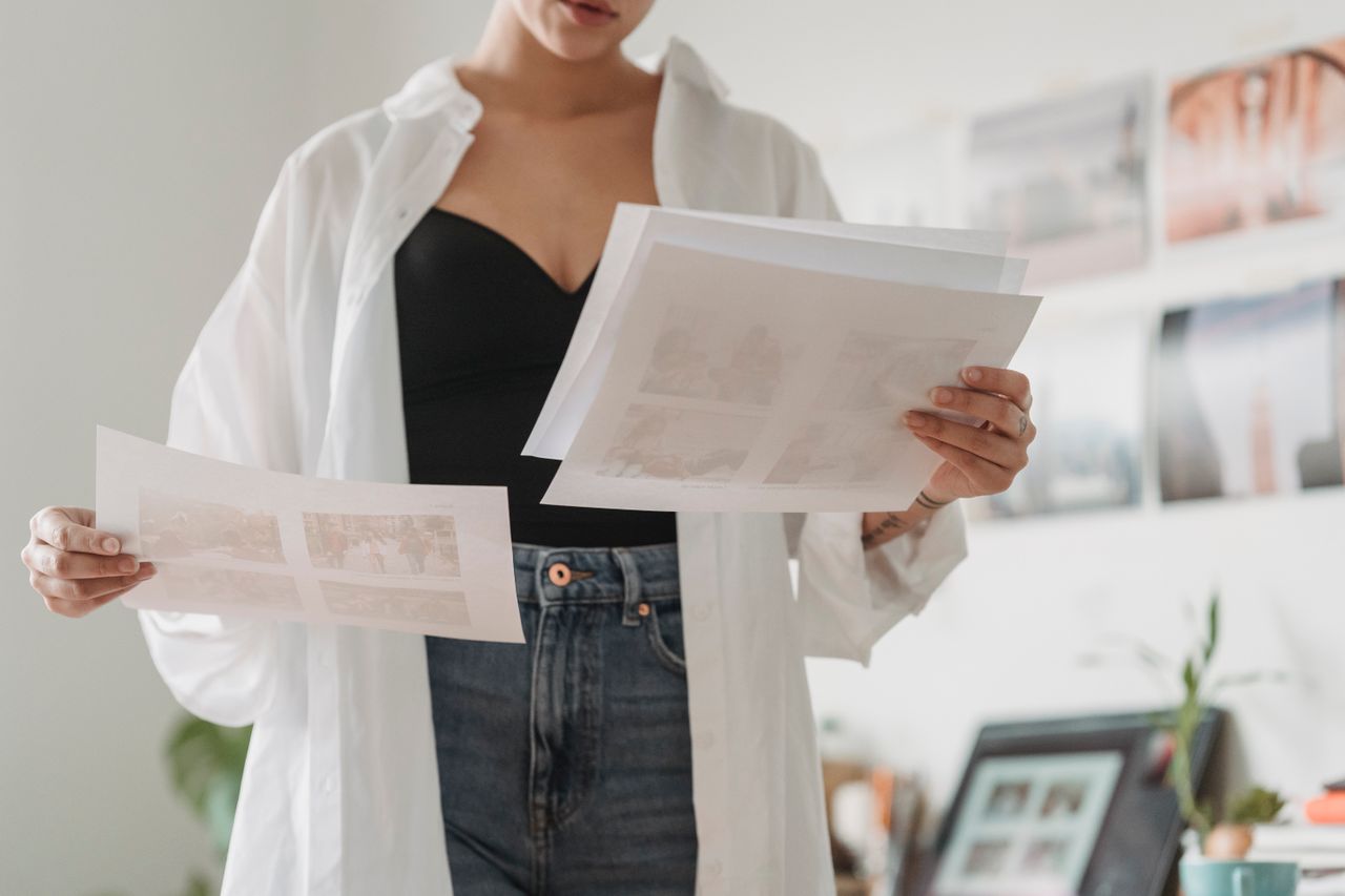 Mastering the First Impression: Your intriguing post title goes here Crop anonymous female employee comparing photos on paper sheets while working on project in light house